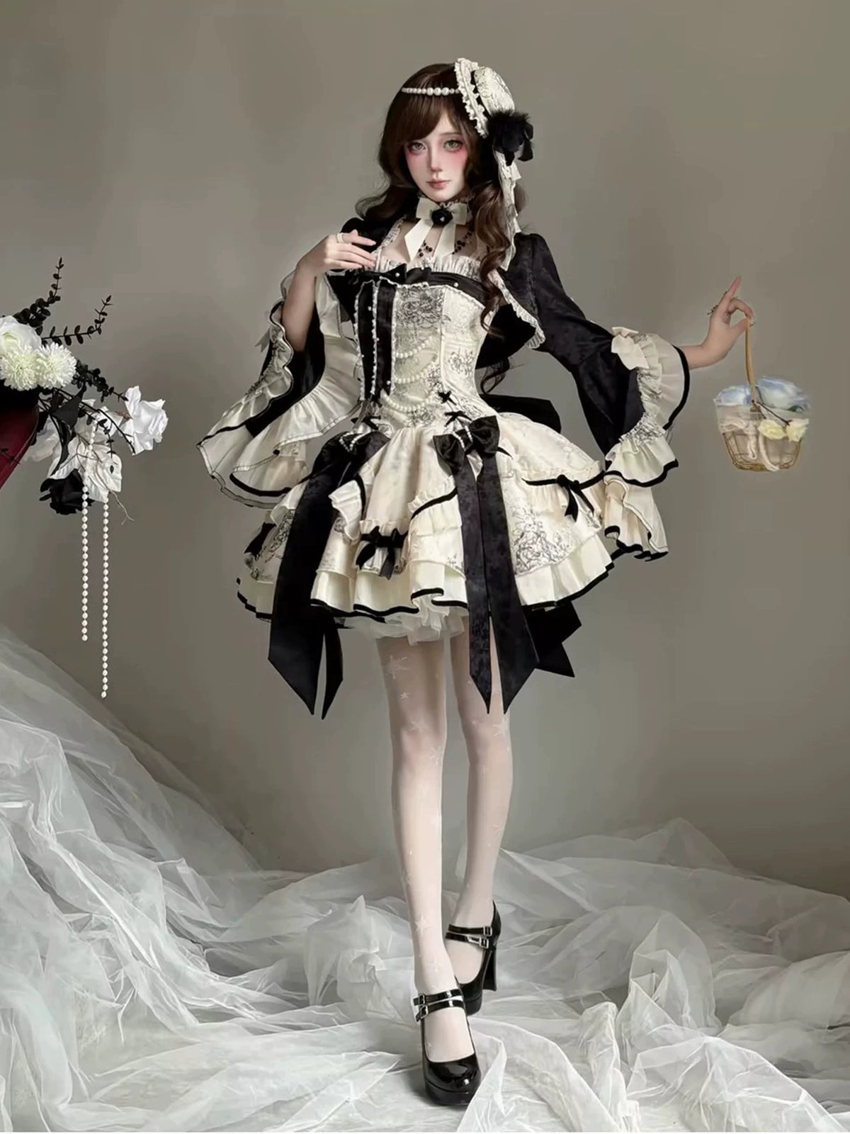 Short black and ivory To Brandy Lolita dress styled with cardigan on model