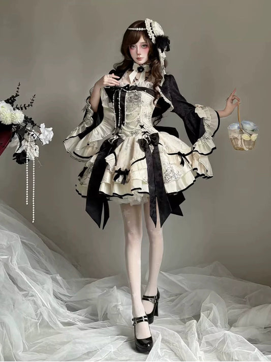 Short black and ivory To Brandy Lolita dress styled with cardigan on model
