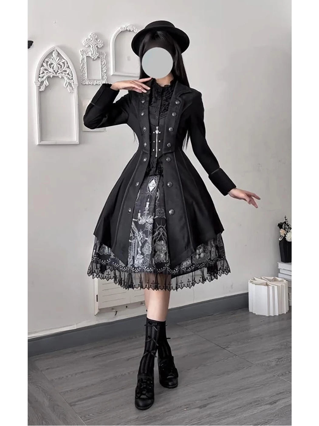 Full-length front view of the black Gothic Ouji coat styled over a patterned dress
