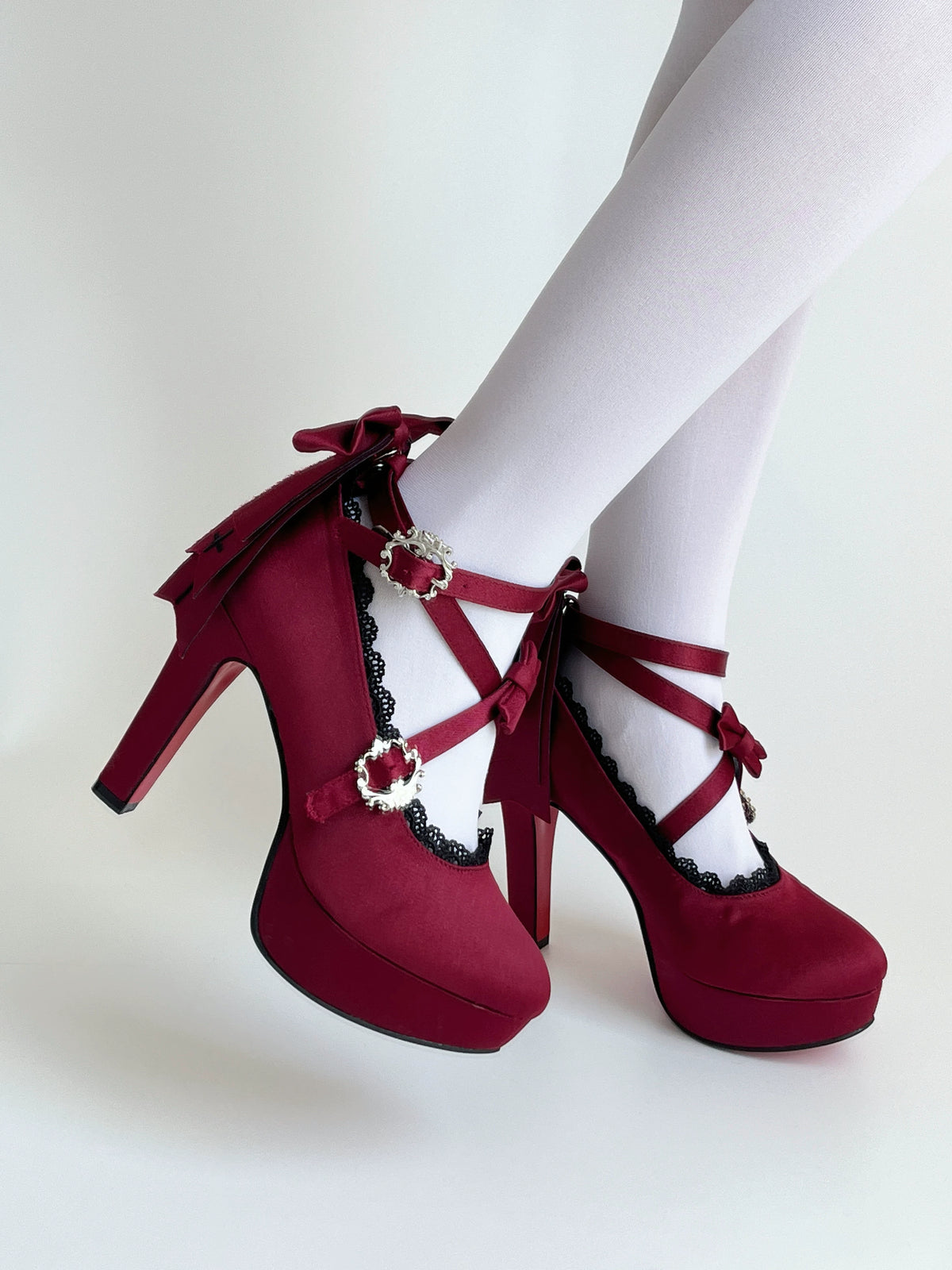 Holy Relic Cross burgundy platform heels worn with crossover straps