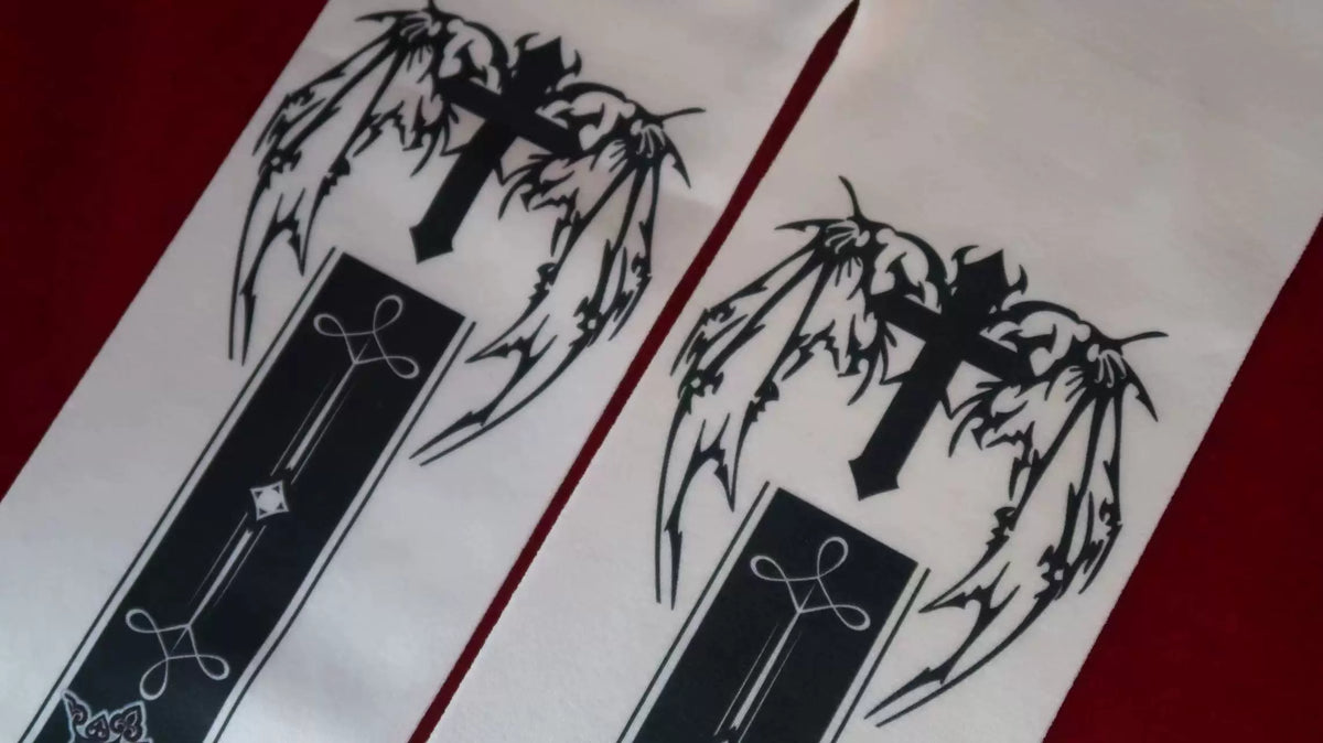Cross and wing motifs on the upper legs of Gothic tights