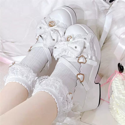 White platform Mary Jane shoes with lace bow and heart details
