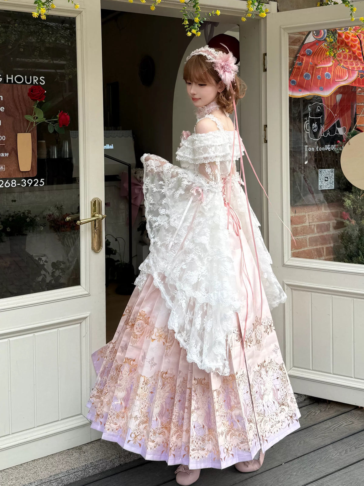 Side view of pink-and-ivory Lolita outfit with draped lace sleeves