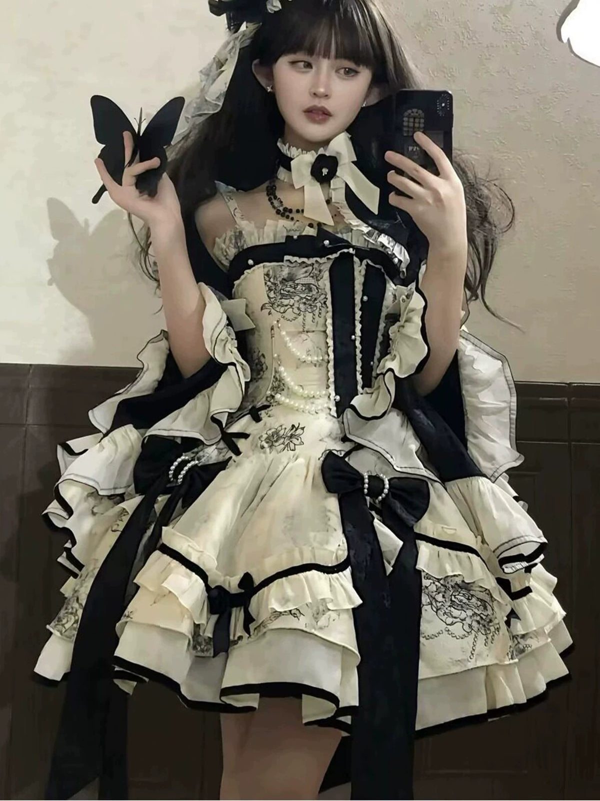 Short Lolita dress bodice showing black bows and ivory lace trim