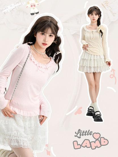 Rosafarbenes, langärmliges Oberteil mit Rüschenbesatz und Schleifendetails