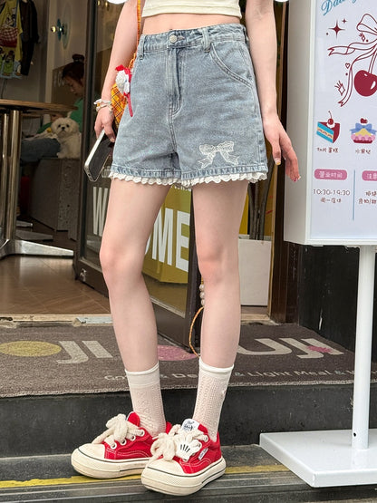 Blaue Jeansshorts mit Schleifenstickerei an den Bündchen und Spitzenbesatz