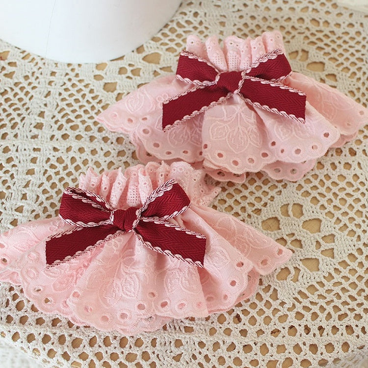 蝶結びのディテールピンクのリストカフス