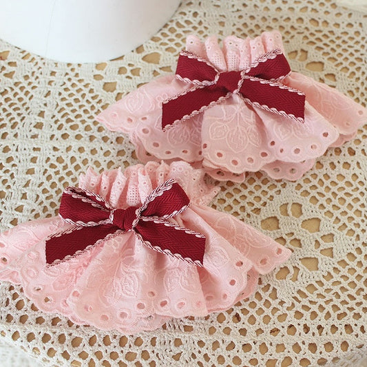 蝶結びのディテールピンクのリストカフス