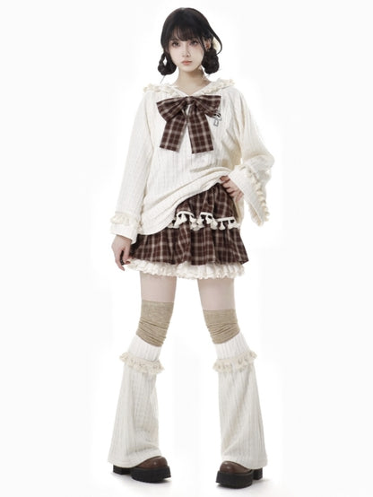 ブラウンのチェック柄ティアードスコート、フリル袖口、フリンジトリム