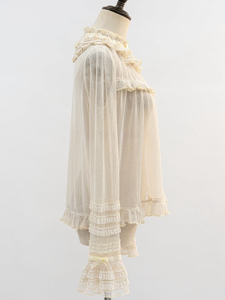 ベージュのフリルネックラインの透け感のある長袖ブラウス