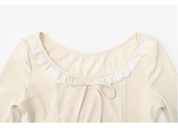 Aprikosenfarbenes, langärmliges Oberteil mit Spitzenbesatz und Schleifendetails