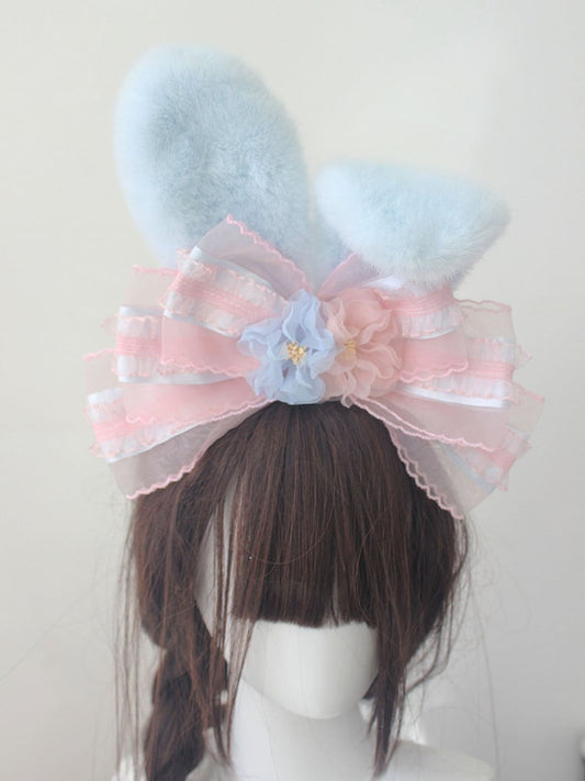 KC rose pastel pelucheux oreilles de lapin bleues