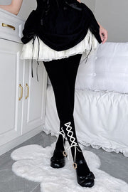 Black lace-up tights styled with a layered skirt