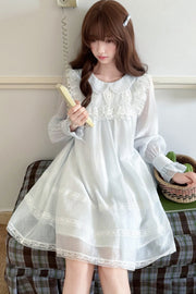 Blue lace-trimmed dress in seated styling