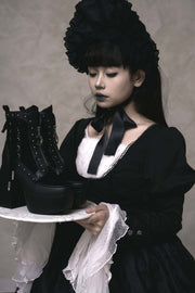 Studded side panel of black ankle boots in styling