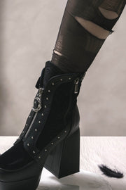 Side view of platform ankle boots worn with hosiery