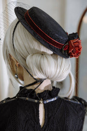 Side view of rose brooch on hat band