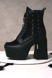 Side profile of black block-heel platform boot