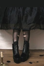 Platform ankle boots worn with a long dark skirt