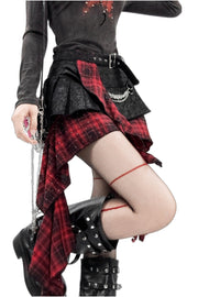 Side drape of red tartan and black skirt
