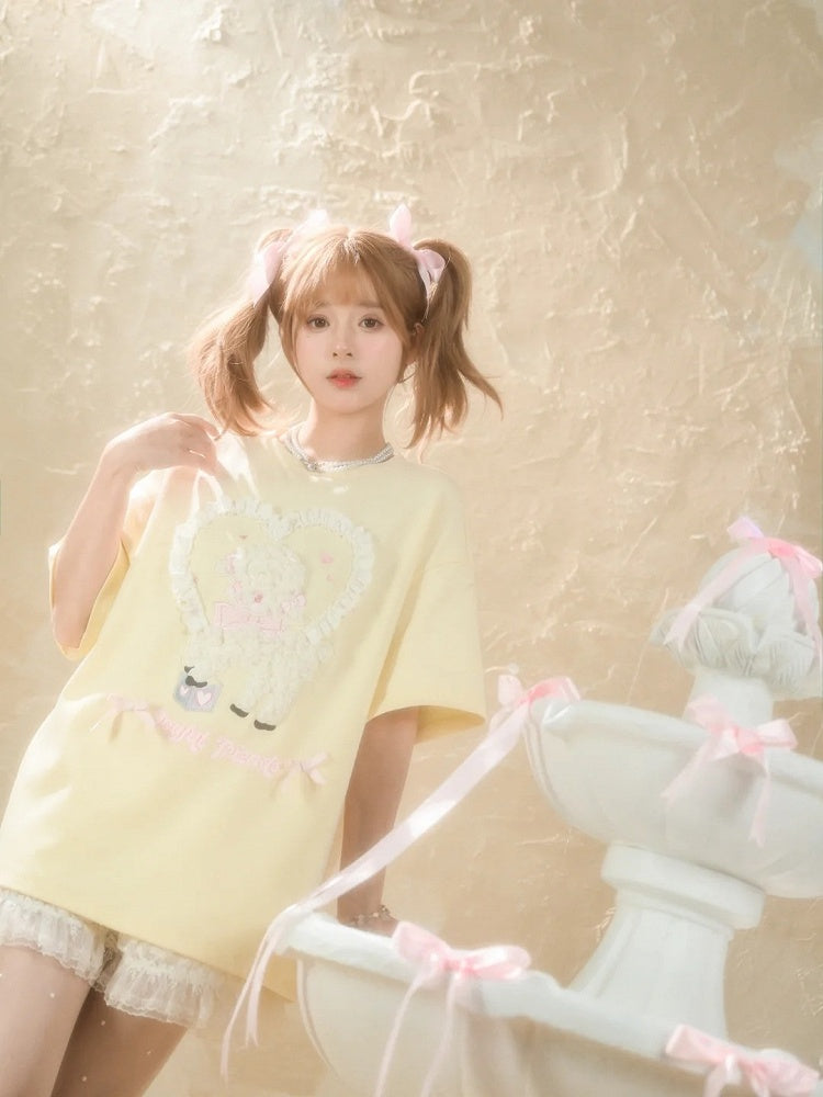 イエローのプラッシュラムアップリケフリルハートルーズTシャツクリーミー