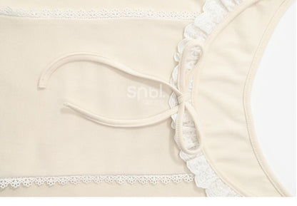 Aprikosenfarbenes, langärmliges Oberteil mit Spitzenbesatz und Schleifendetails