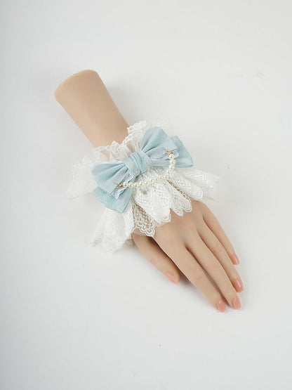 Blaue Handgelenkmanschetten mit großer Schleife, Rüschenspitze und Perlenkette