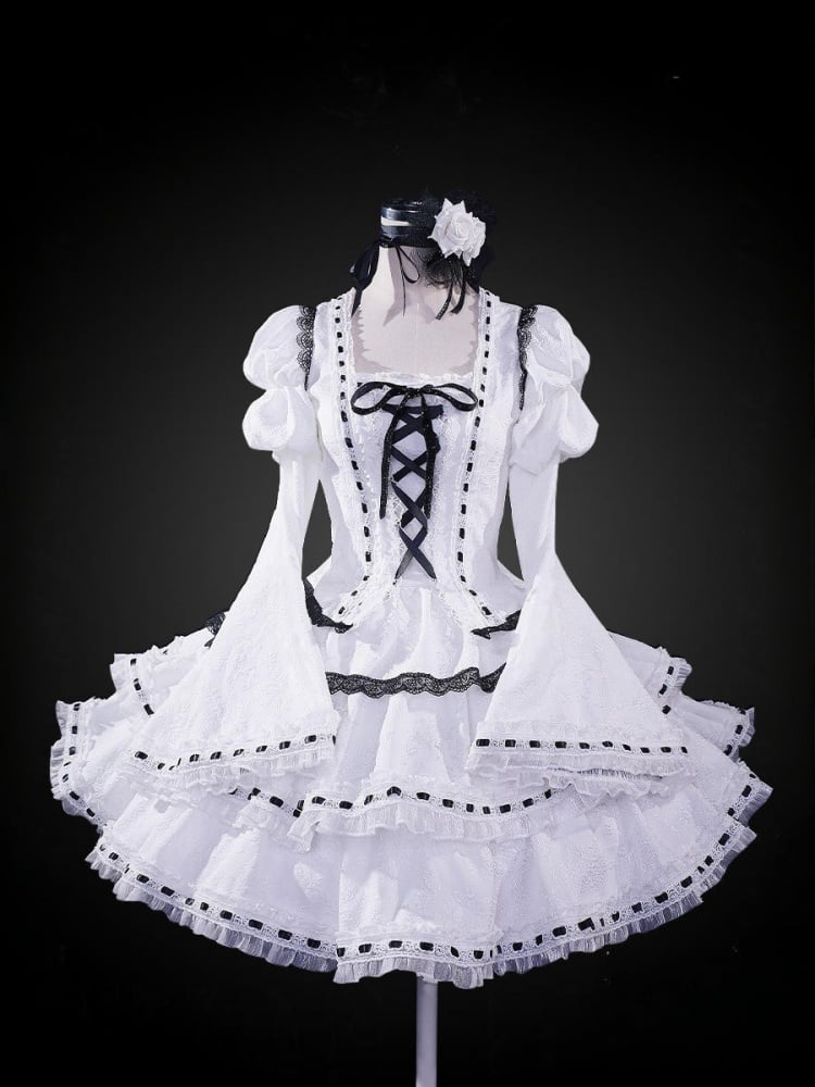 A white lace-up detail, ruffle trim, and bell sleeves cosplay costume dress on a mannequin, with a headpiece and socks included.
