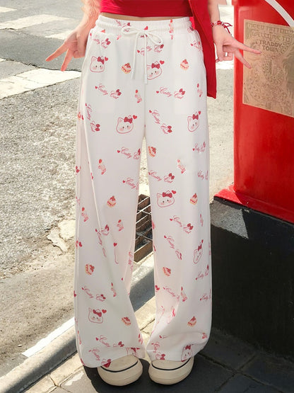 ホワイトのドローストリングウエスト、全体にキティプリントのワイドレッグカジュアルパンツ