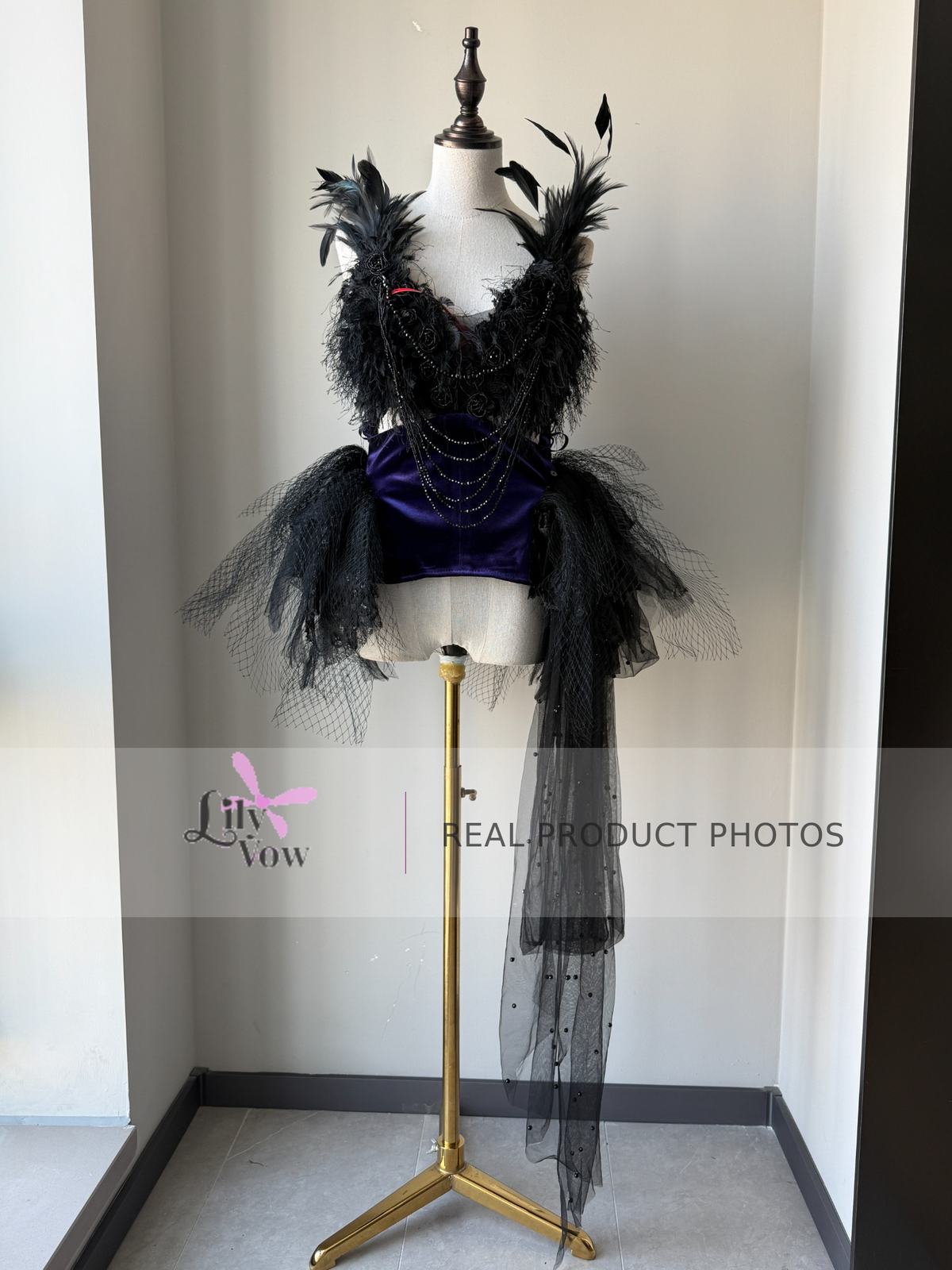 Real product photo of black and purple feather-adorned Gothic ballet dress, front view