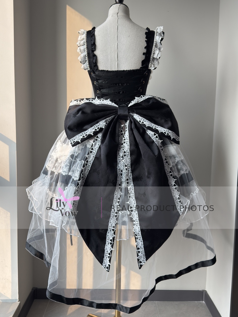 Back real product photo of black and white decorated Lolita JSK with bow train
