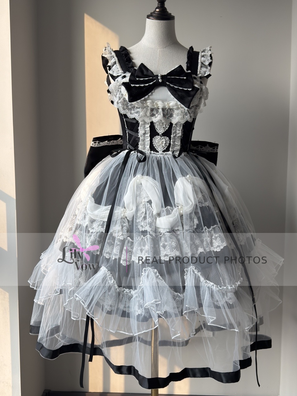 Front real product photo of black and white decorated Lolita JSK with lace overlay