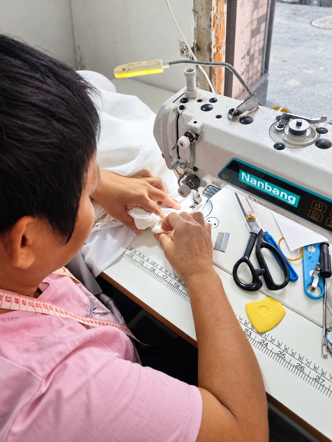 LilyVow alteration specialist with over 20 years of experience working at a professional sewing machine
