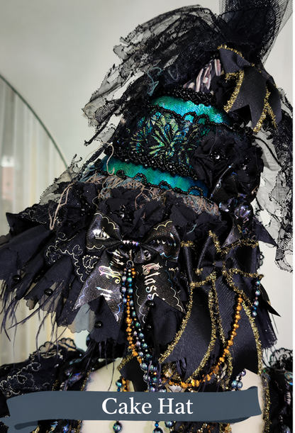 Moss Bone Butterfly Cake Hat with black lace and iridescent butterfly decoration