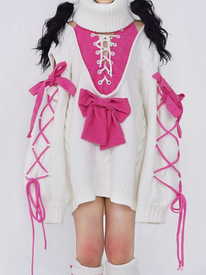 ピンクの蝶結びの白いタートルネックセーター